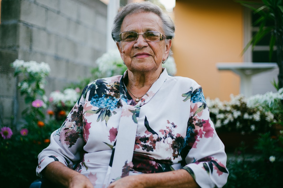 senior woman sitting outside