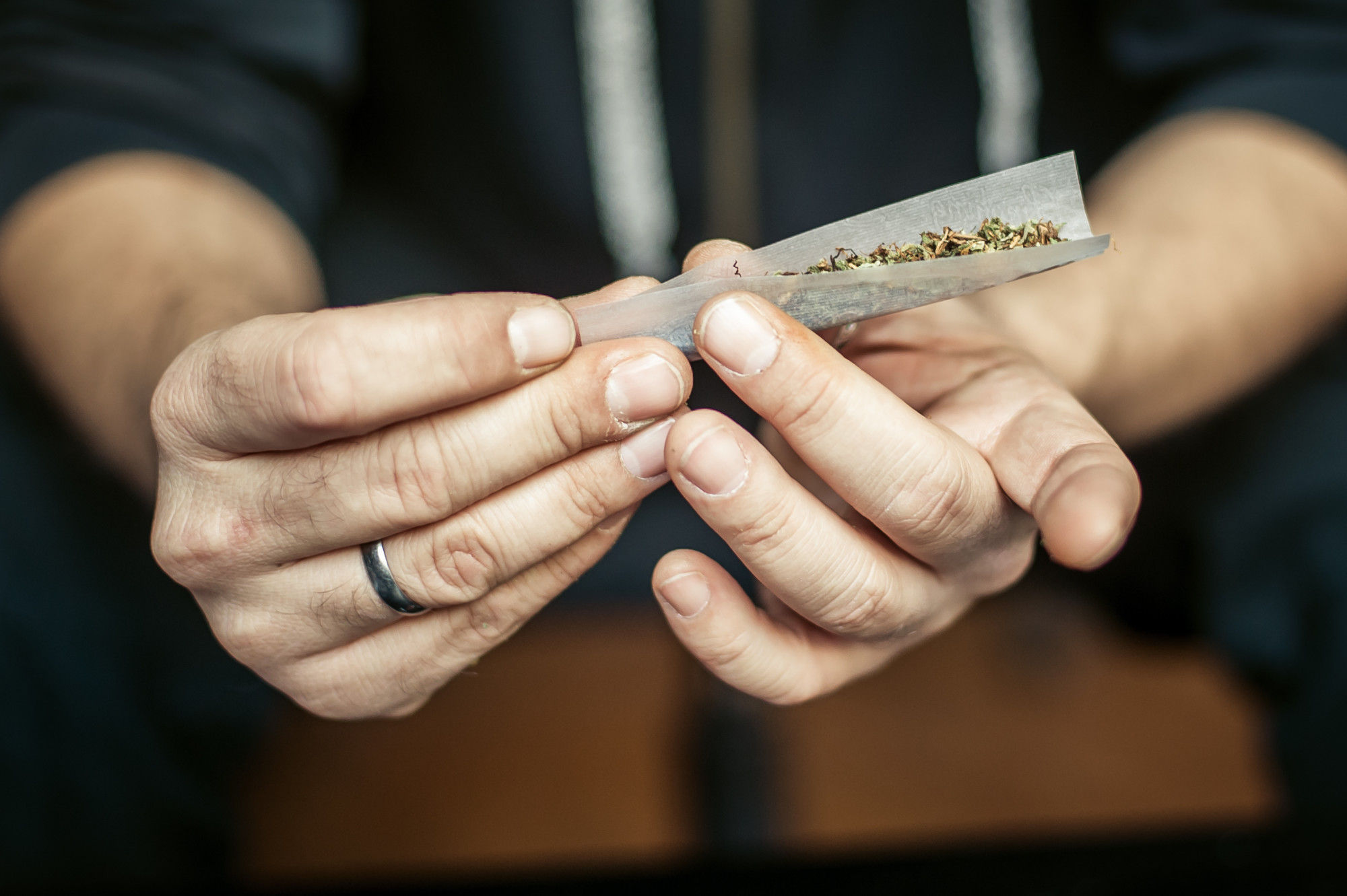 person rolling weed joint