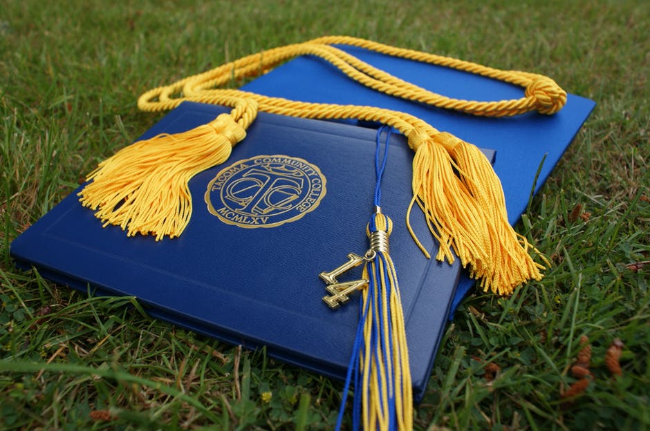 college diploma and graduation hat