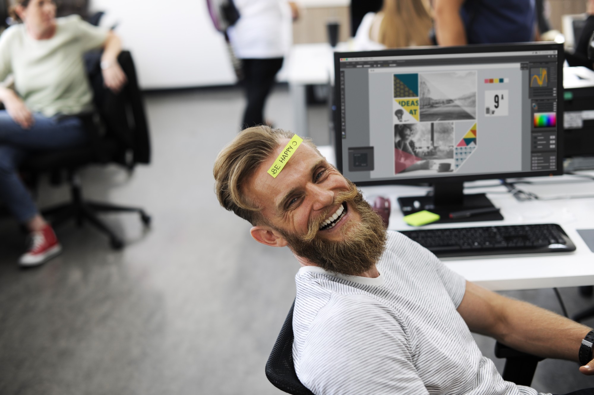 smiling man with be happy sticker on forehead