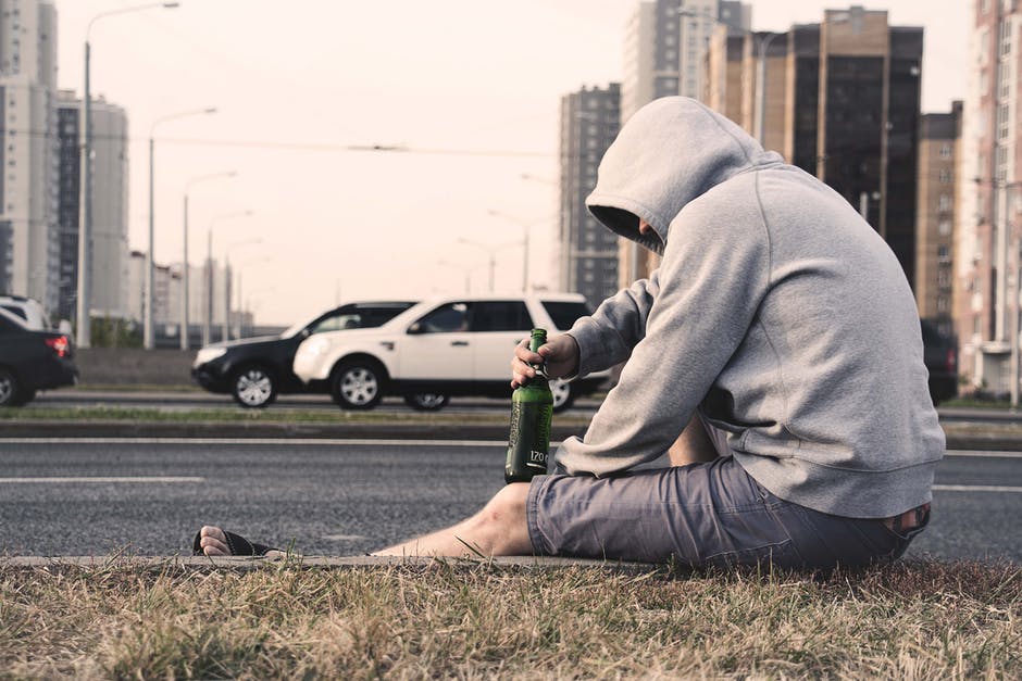 drunk man sitting on curb