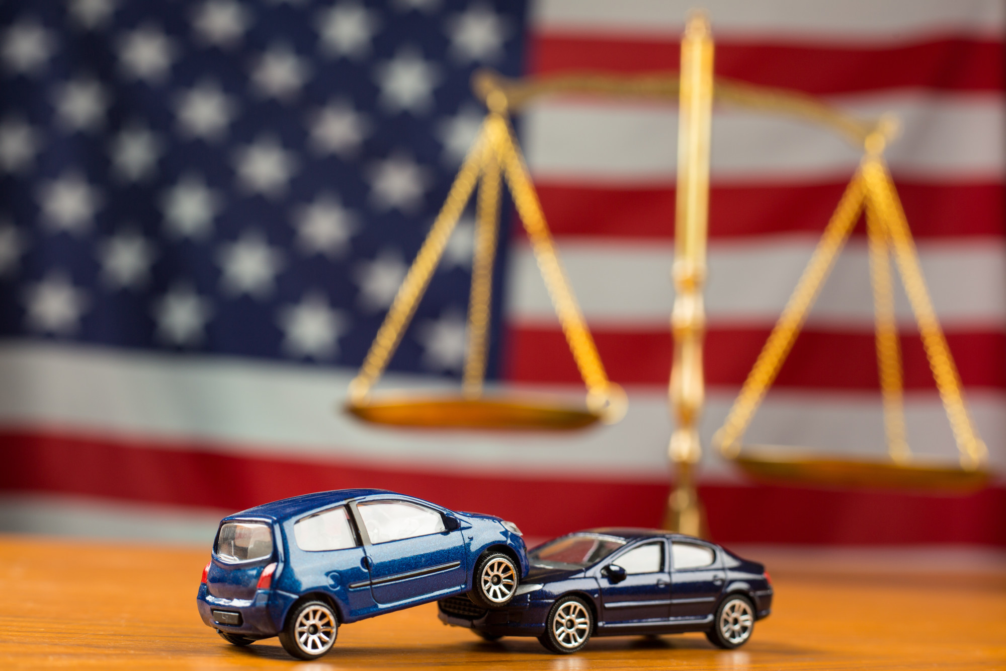 Car Accident Demonstrated Using Die Cast Toys with Law Scale and American Flag in the Background